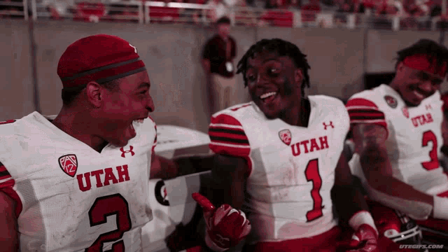 a group of utah football players are laughing