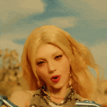 a woman with blonde hair is wearing chains around her arms