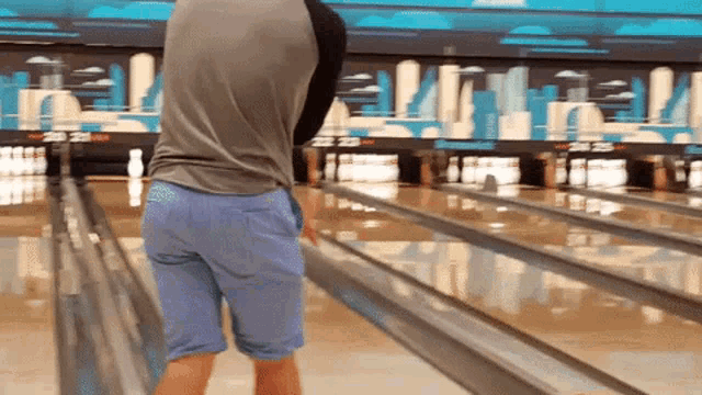 a man in a bowling alley with the number 22 on the wall