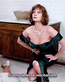 a woman in a green dress is kneeling down and saying it 's my defense mechanism .