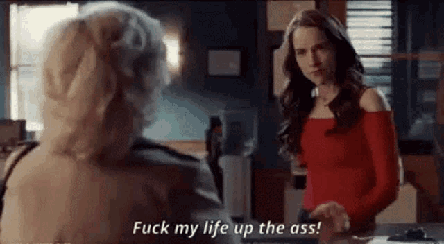 two women are standing next to each other and one of them is saying `` fuck my life up the ass ! ''