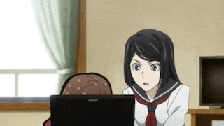 a girl in a sailor suit is looking at a laptop computer .