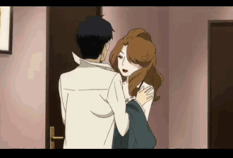 a man and a woman are hugging in a hallway