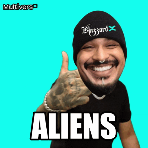 a man wearing a beanie and a t-shirt with the word aliens on it
