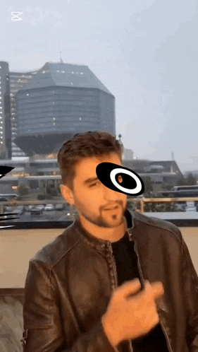 a man wearing a leather jacket has a circle on his face