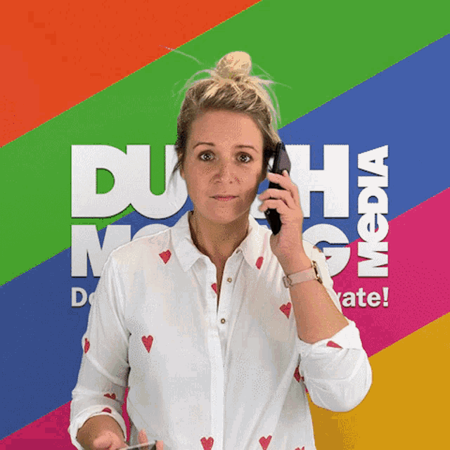 a woman talking on a cell phone in front of a colorful background that says duha media