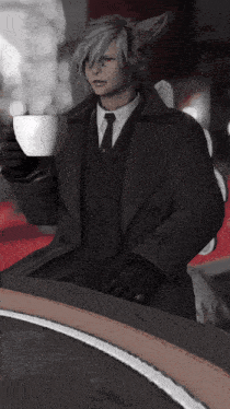 a man in a suit holding a cup of coffee