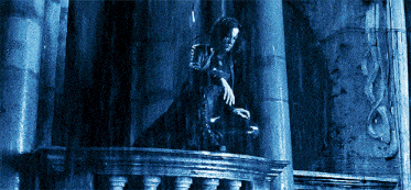 a person standing on a balcony in the rain with a blue background