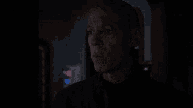 a man in a dark room with the words oh dear above him