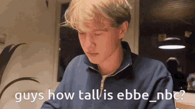 a man in a blue sweater is asking how tall he is