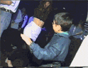 a man in a blue jacket holds a woman 's butt