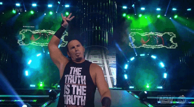 a wrestler wearing a black tank top that says the truth is the truth