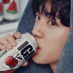 a close up of a person drinking from a can with the letter g on it