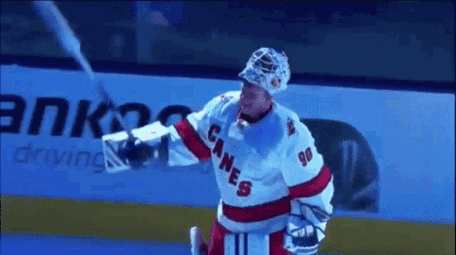 a hockey player with the number 90 on his jersey is holding a puck