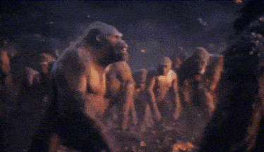 a close up of a gorilla 's face with flames in the background