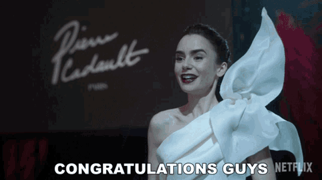 a woman in a white dress is smiling and says congratulations guys