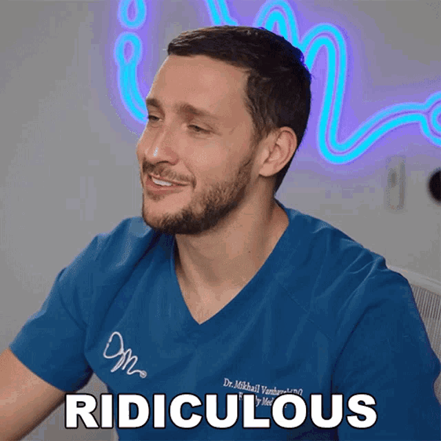 a man with a beard wearing a blue scrub top says ridiculous