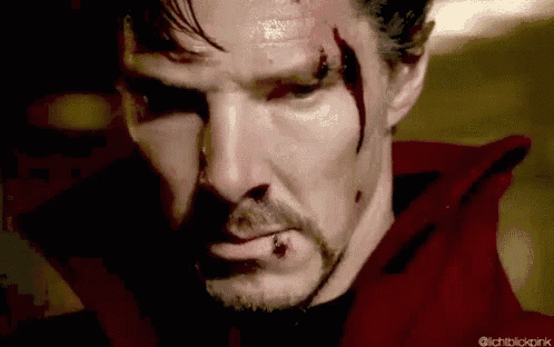 a close up of a man 's face with blood on it and a red jacket .