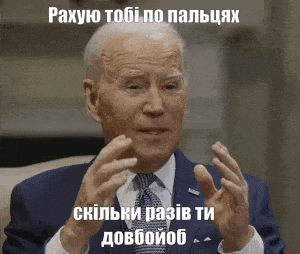 a man in a suit and tie is talking with his hands outstretched .