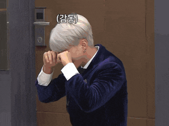 a man is laying on a couch with his head in his hands in korean