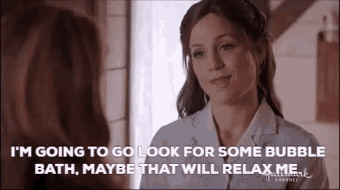 a woman is talking to another woman and saying `` i 'm going to go look for some bubble bath .