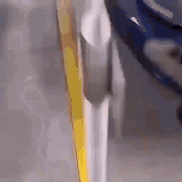 a close up of a metal pipe with a yellow line on it
