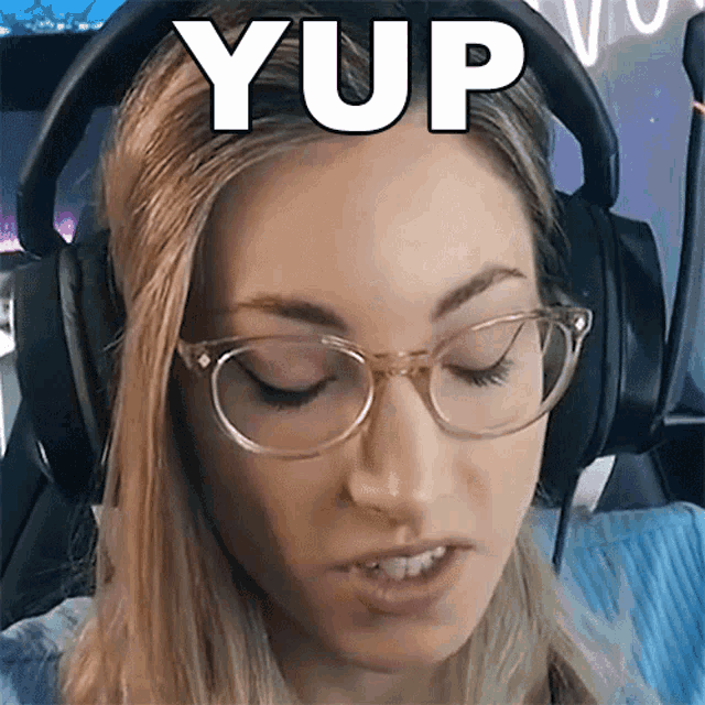 a woman wearing glasses and headphones has the word yup written on her head