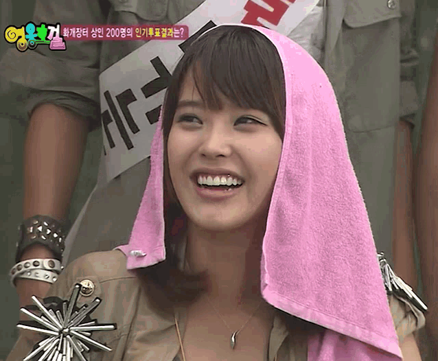 a woman wearing a pink towel around her head has a sign that says 200