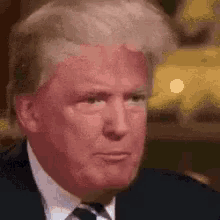a man in a suit and tie is making a funny face .