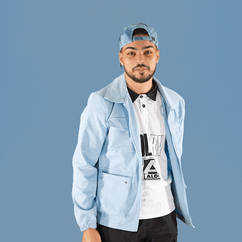 a man wearing a light blue jacket and a white shirt with aldi written on it