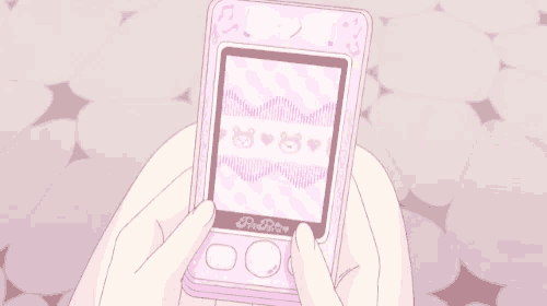 a person is holding a pink toy in their hands .