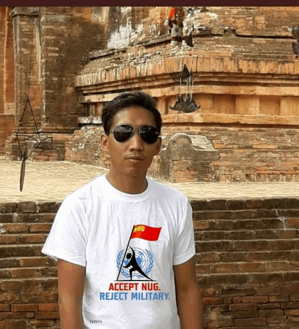 a man wearing a white t-shirt that says accept nug reject military