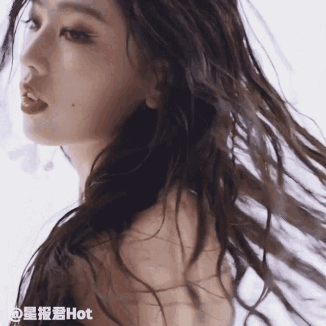 a close up of a woman 's face with the words hot on the bottom right