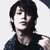 a close up of a young man 's face with a serious look on his face .