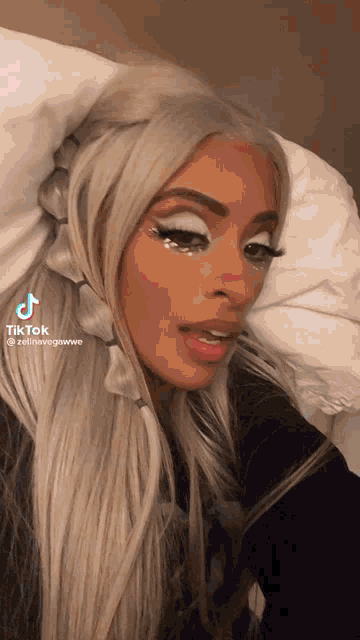 a woman laying on a bed with a tiktok watermark