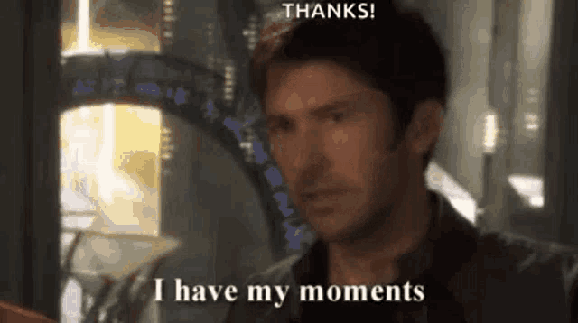a man is saying `` thanks ! i have my moments '' while holding a book .