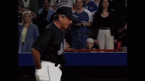 a dunkin donuts sign is behind a baseball game