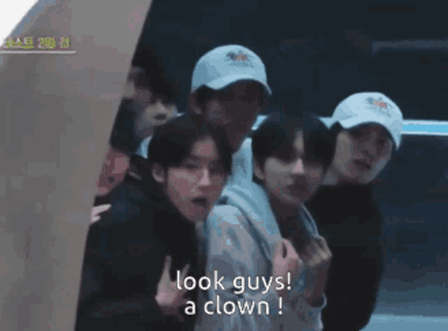 a group of young men are posing for a photo and one of them says " look guys a clown "