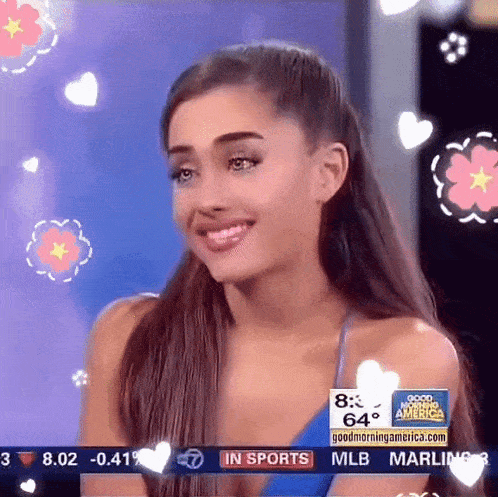 ariana grande is smiling in front of a screen that says good morning america