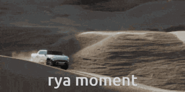 a car is driving down a dirt road and the words rya moment are on the bottom of the image