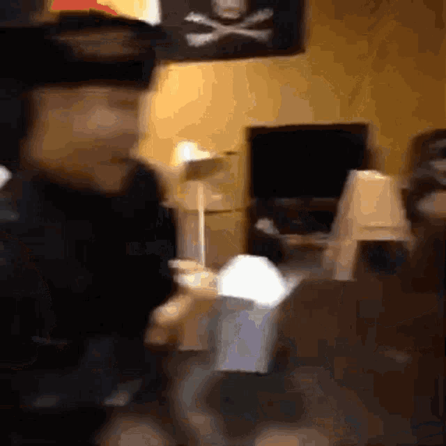 a blurry picture of a man standing in a room