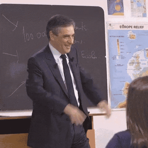 a man in a suit and tie stands in front of a blackboard that says europe relief on it