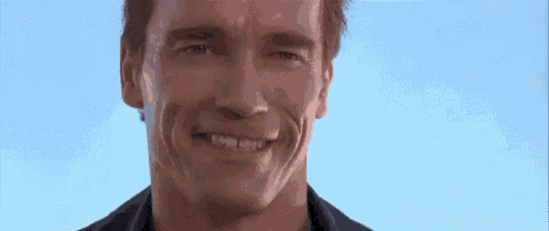 a close up of a man 's face with a blue sky in the background .