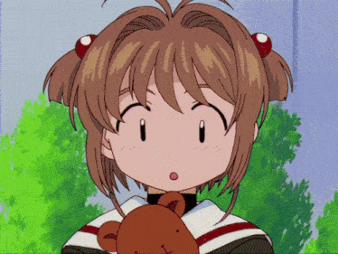 a girl holding a brown teddy bear looks surprised