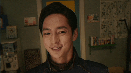 a close up of a young man making a funny face in a room .
