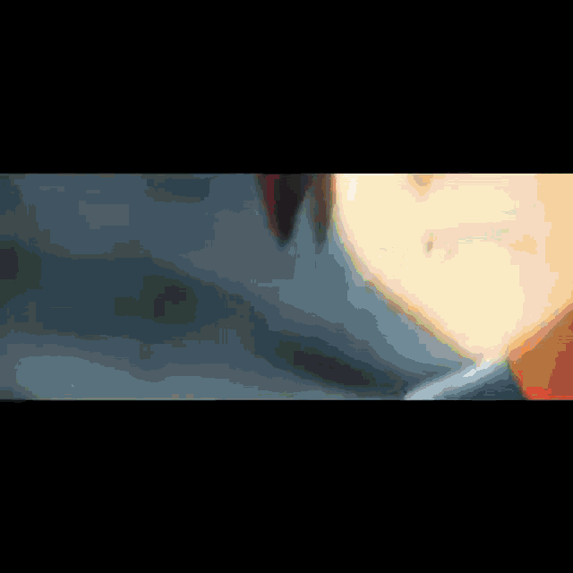 a blurred image of a person 's face with a red glow