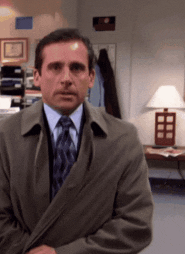 a man in a suit and tie is looking at the camera