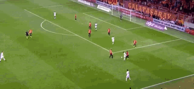 a soccer game is being played in front of a banner for denizbank
