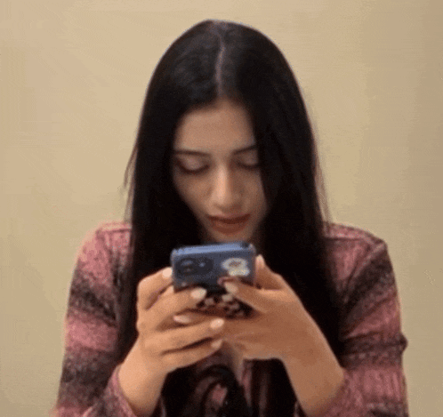 a woman is holding a cell phone in her hands with the number 8 on it