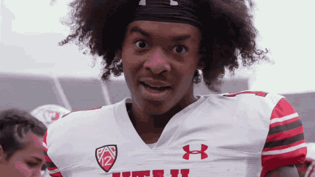 a football player wearing a white under armour shirt